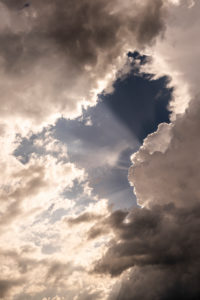 Wolkenstimmung mit Sonnenstrahlen während einem aufziehenden Unwetter Wolkenstimmung mit Sonnenstrahlen während einem aufziehenden Unwetter